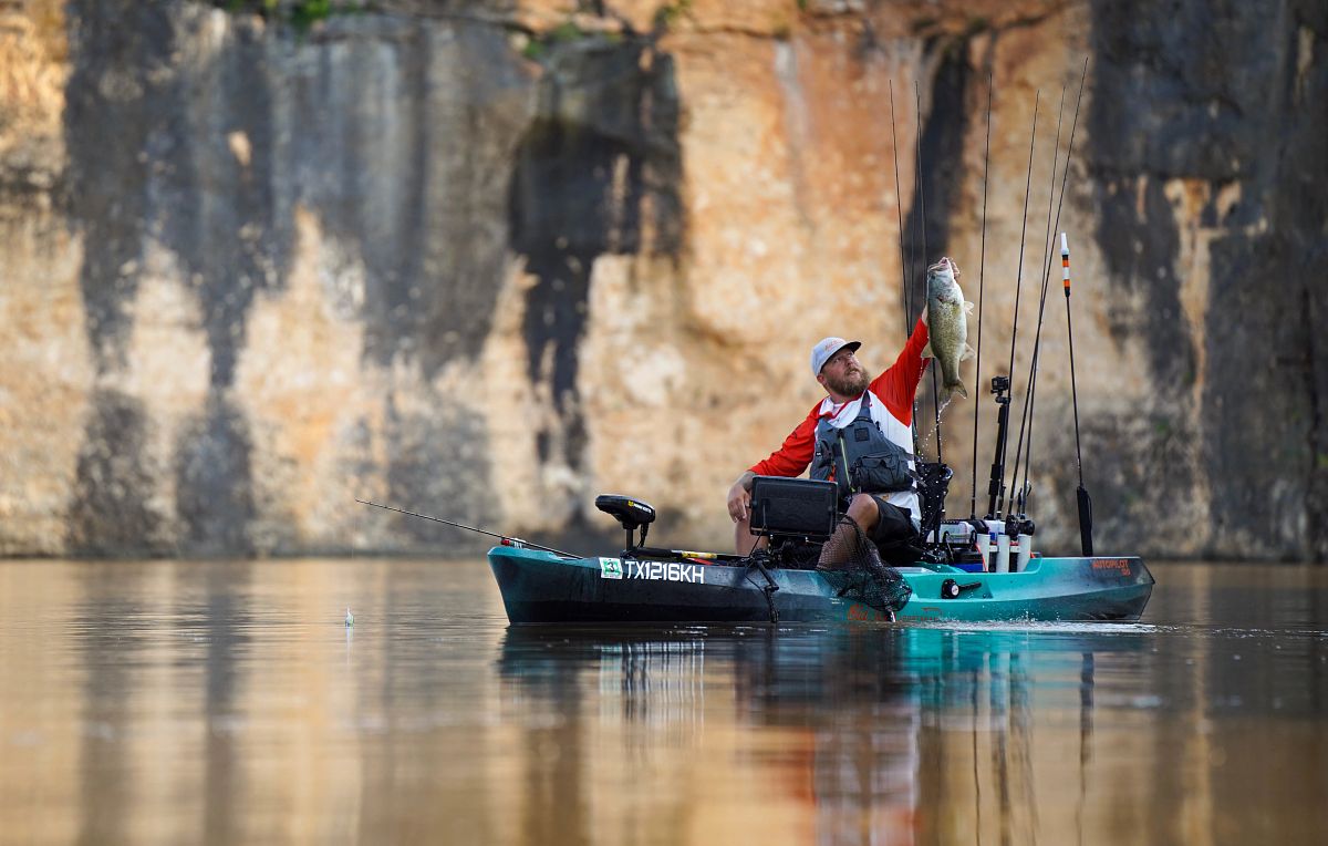 Kayak man holding fish