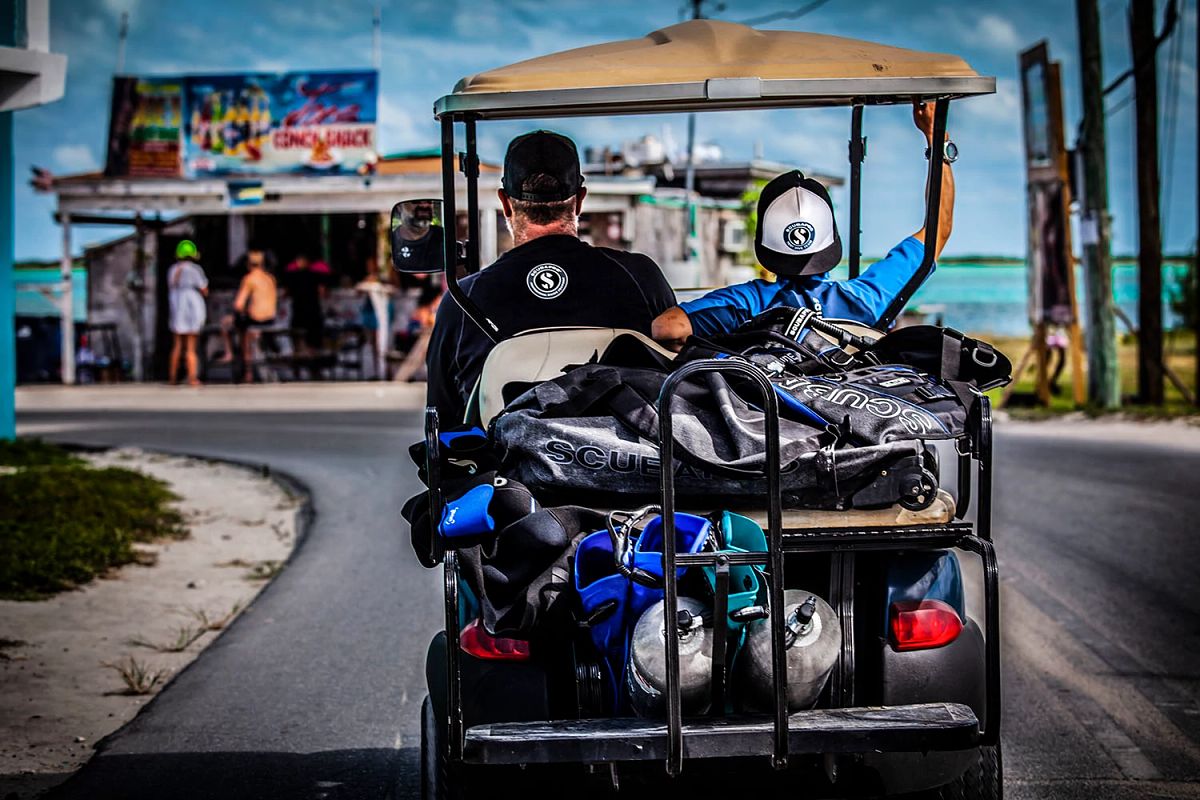 Two men travelling in golf cart