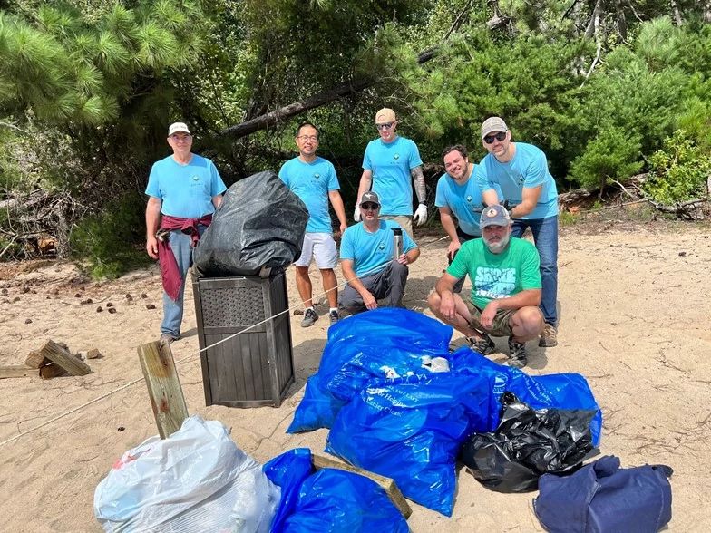 Group of Humminbird employees with trash they picked up on beach